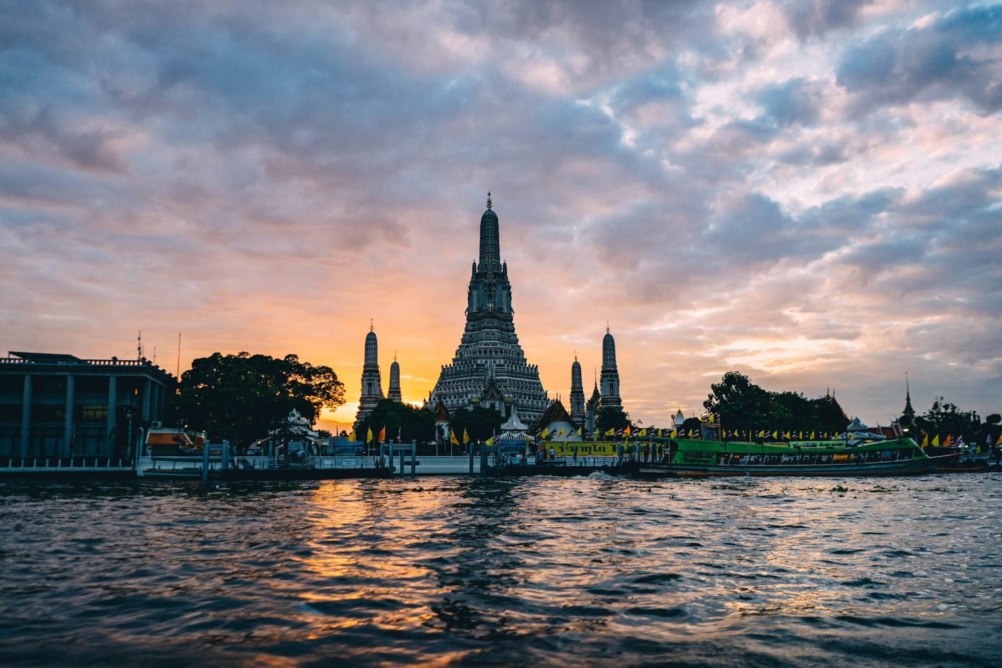 Wat Arun temple at sunset across the Chao Phraya River, Bangkok